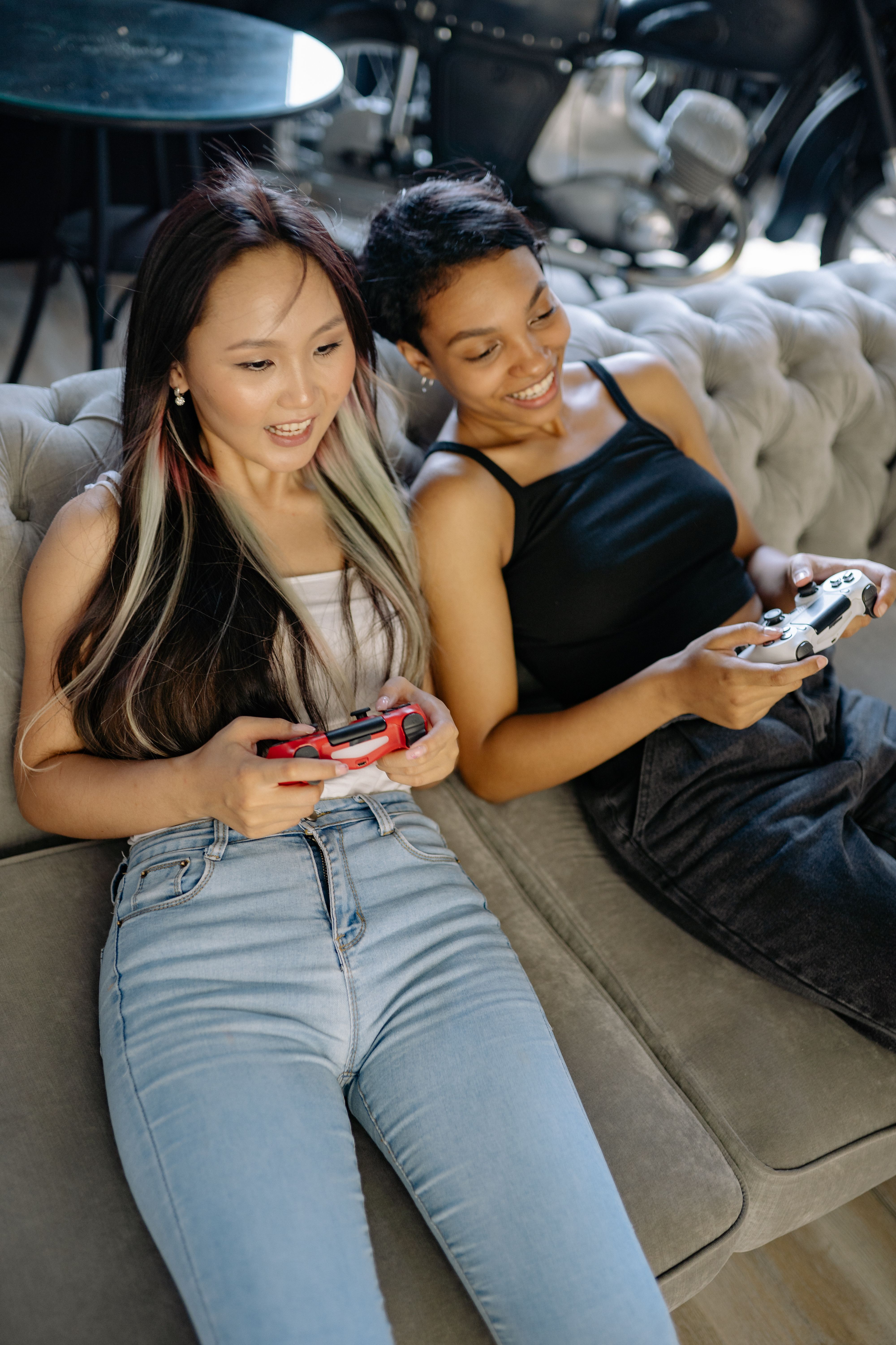 Two people playing a multiplayer game together on a couch